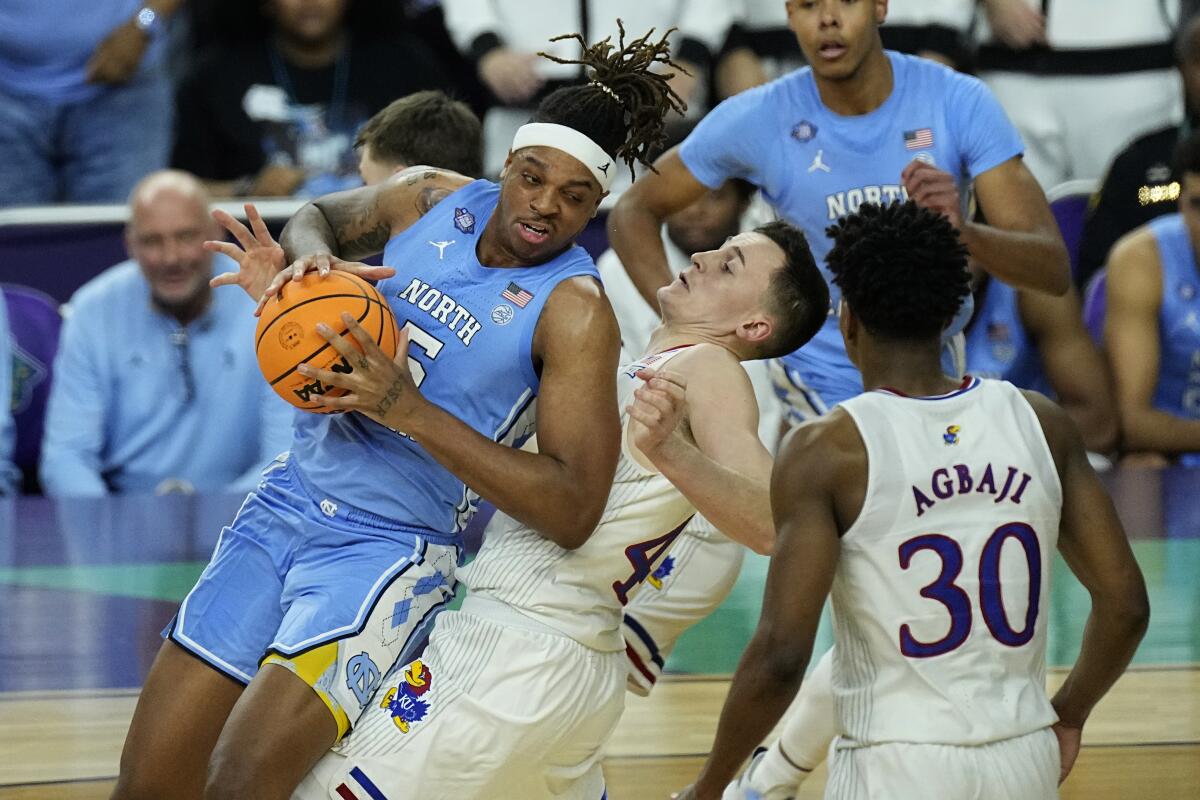 Kansas forward Mitch Lightfoot draws the foul against North Carolina forward Armando Bacot.