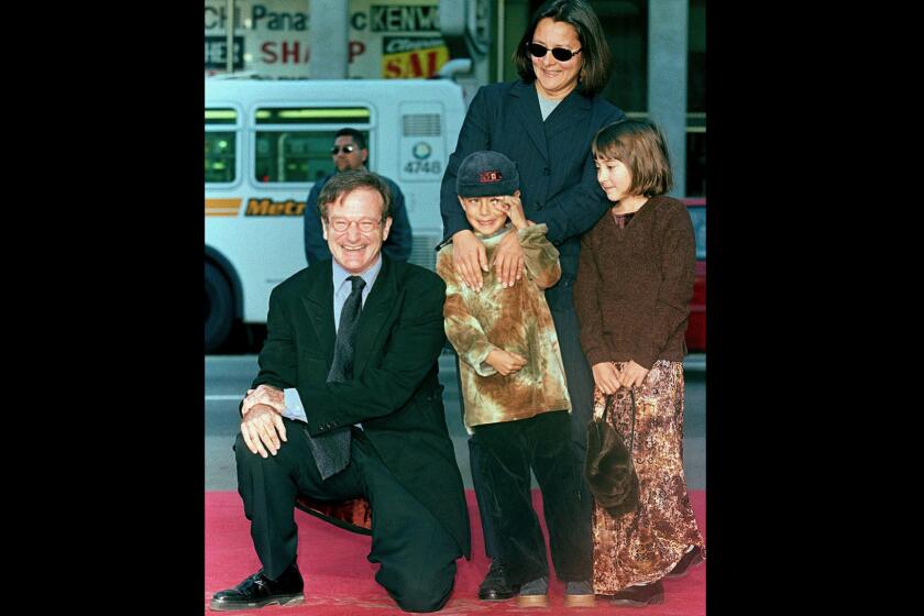 Robin Williams with son Cody, center, daughter Zelda and then-wife Marsha Garces in December 1998 at the actor's handprint and footprint ceremony on Hollywood Boulevard. Son Cody Williams joined his mom and older siblings Tuesday in issuing statements the comic-actor.