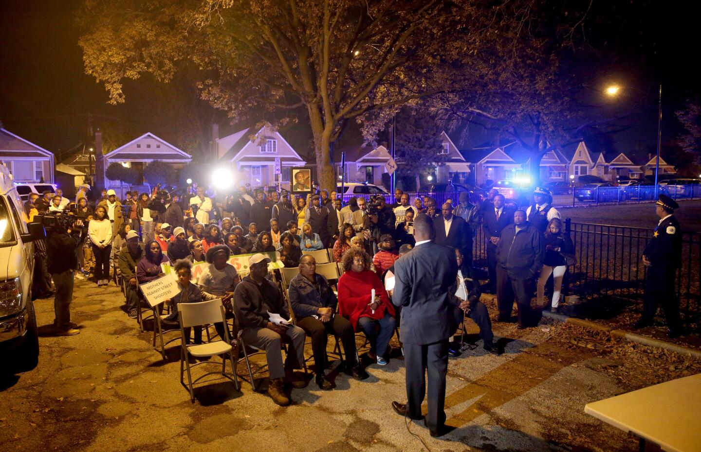 Auburn Gresham community residents listen during an Operation: Wake Up! event put on by the Chicago Police Department in the 8000 block of South Damen Avenue on Nov. 3, 2015. Tyshawn Lee, 9, was shot and killed in a nearby alley Nov. 2.