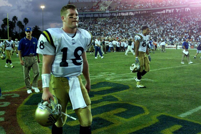 UCLA quarterback Cade McNown walks off the field after a 49–45 loss to Miami at the Orange Bowl in 1998.