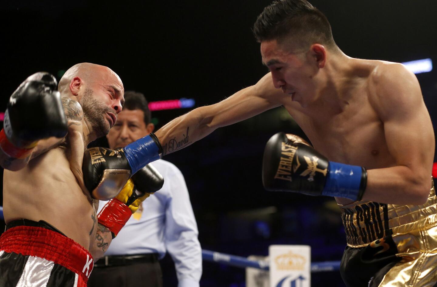 Kiko Martinez is knocked to the ground by a shot from Leo Santa Cruz during their World Featherweight title bout at the Honda Center on Feb. 27.