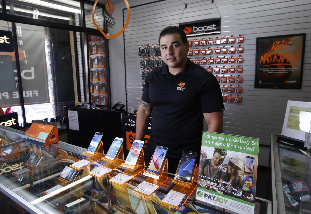 Gary Fuentes at La Fiesta Wireless in El Monte says more of his prepaid phone customers are buying high-end smartphones instead of cheaper models, thanks to a growing number of companies offering financing plans.