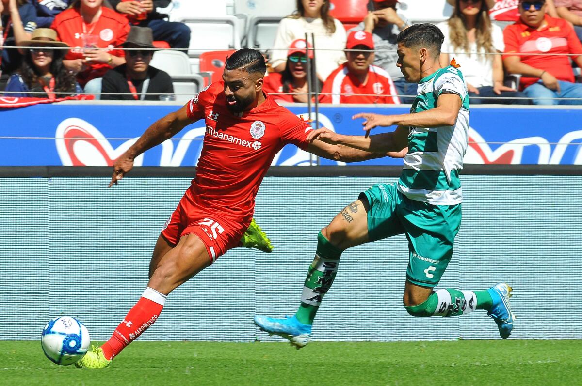 Pedro Canelo (L) of Toluca vies for the ball with Gerardo Arteaga (R) of Santos during the Mexican Apertura 2019 tournament football match at Nemesio Diez stadium in Toluca, Mexico state, Mexico on November 24, 2019. (Photo by ROCIO VAZQUEZ / AFP) (Photo by ROCIO VAZQUEZ/AFP via Getty Images) ** OUTS - ELSENT, FPG, CM - OUTS * NM, PH, VA if sourced by CT, LA or MoD **