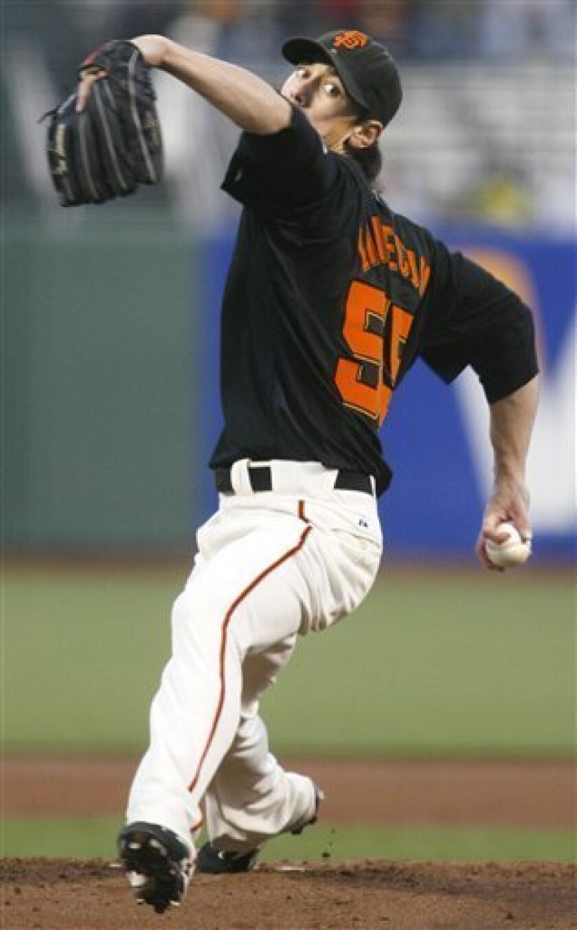 San Francisco Giants pitcher Tim Lincecum throws to the Oakland Athletics in the first inning of an exhibition baseball game, Thursday, April 2, 2009 in San Francisco. (AP Photo/Dino Vournas)
