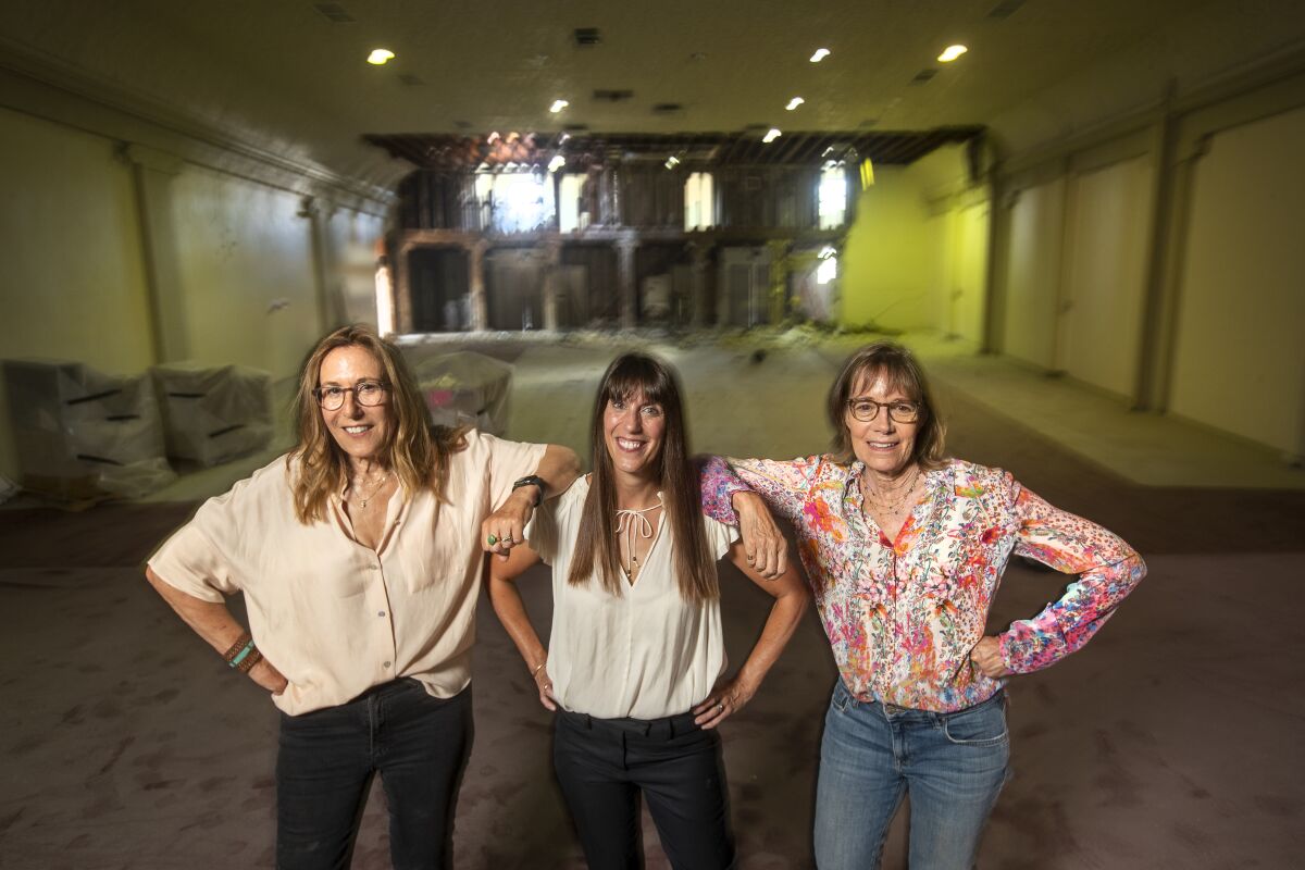 Maggie Mackay, center, Patty Polinger, left, and Cathy Tauber, right, inside the new location for Vidiots. 