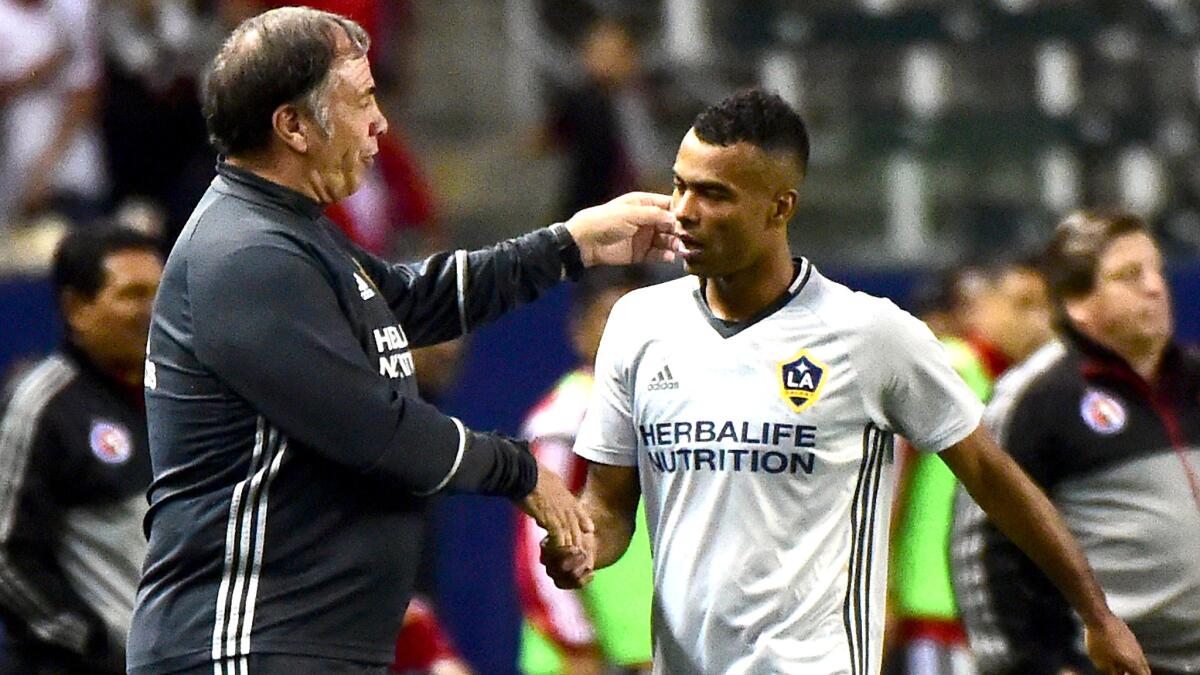 Galaxy Coach Bruce Arena congratulates defender Ashley Cole after substituting for the England star during a preseason game against Club Tijuana on Feb. 9.
