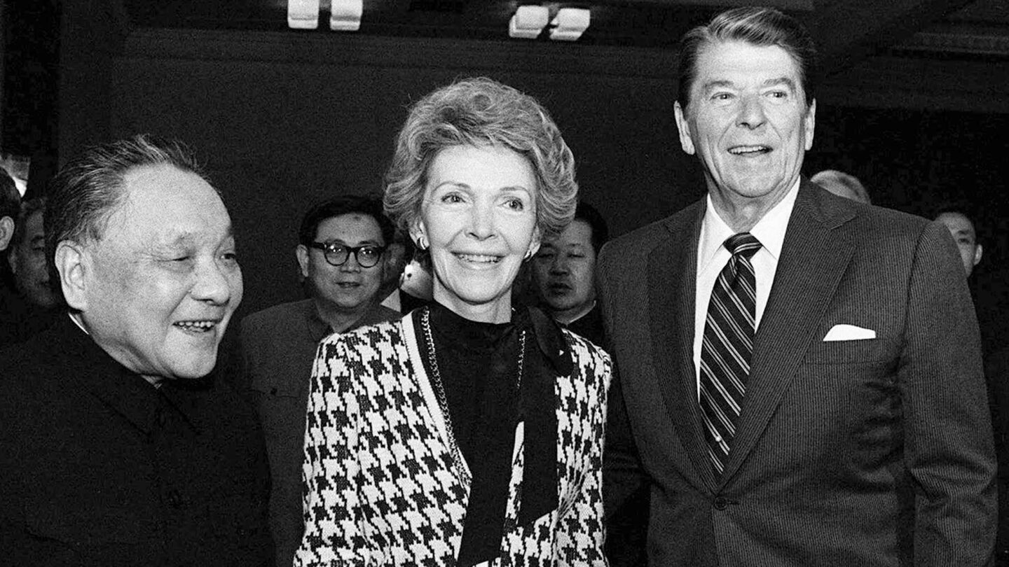 Nancy Reagan holds Chinese leader Deng Xiaoping's hand during a 1984 visit to Beijing. The first lady took an active role in advising President Reagan on policy matters.