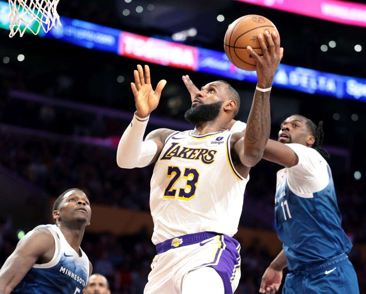 Lakers star LeBron James puts up a shot in front of Minnesota's Naz Reid.