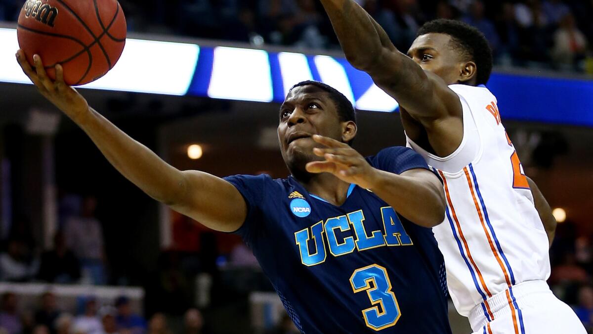 UCLA's Jordan Adams puts up a shot in front of Florida's Casey Prather during the Bruins' loss in the NCAA regional semifinal on March 27, 2014.