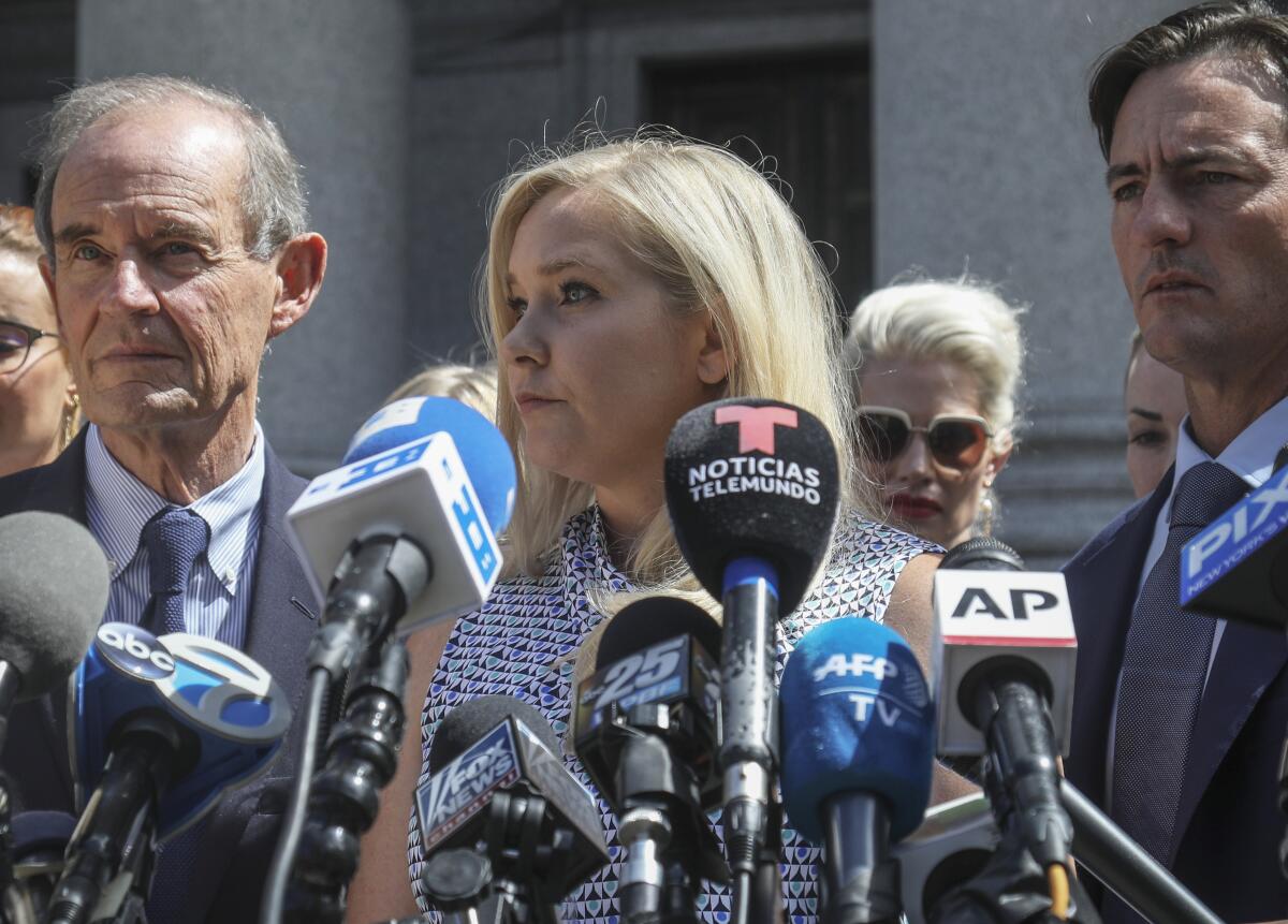 Virginia Roberts Giuffre, center,  outside a Manhattan court in August. 