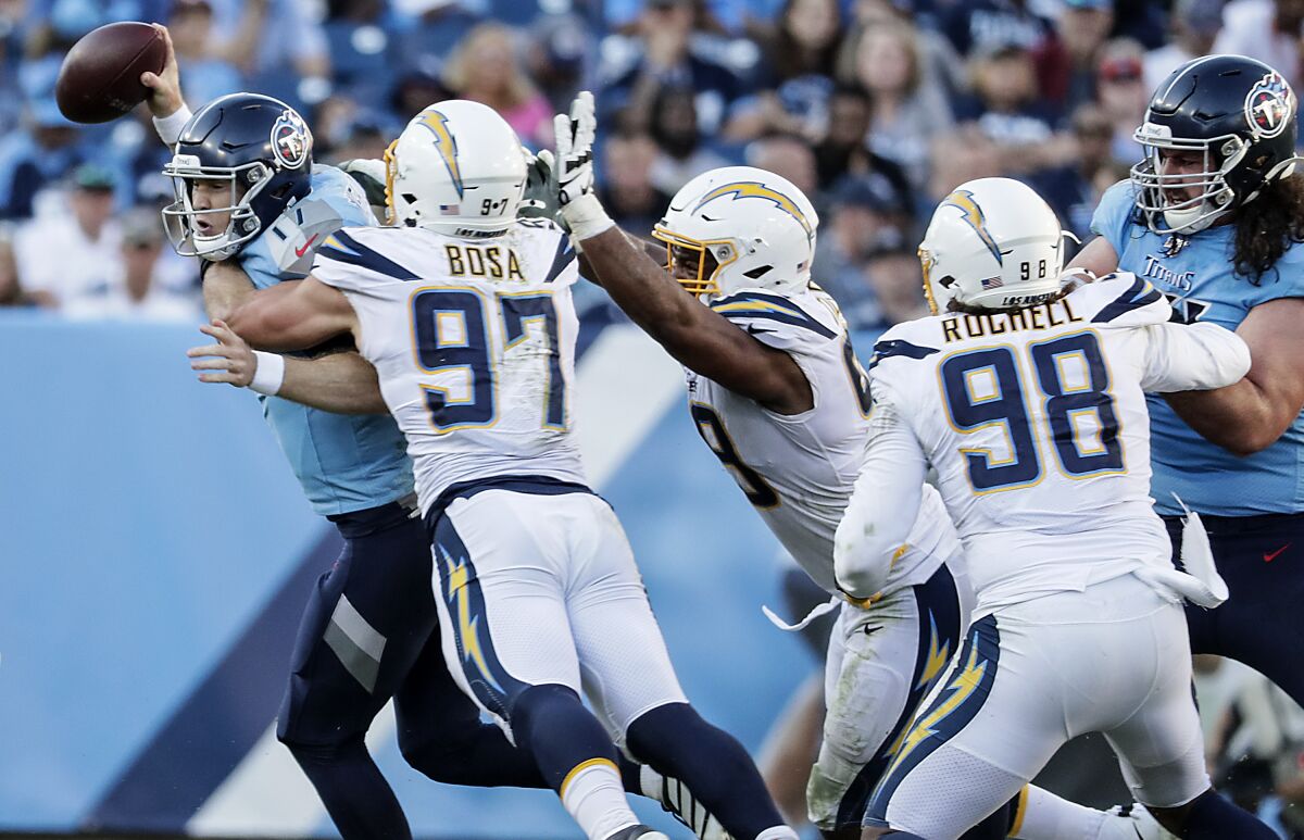 Chargers defensive end Joey Bosa (97) sacks Tennessee Titans quarterback Ryan Tannehill (17) during second half on Sunday in Nashville.