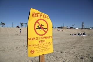 SEAL BEACH, CA - JANUARY 02: A sign at Seal Beach warns visitors to stay out of the water on Sunday, Jan. 2, 2022. Southland beaches remain closed due to a raw sewage spill in the Dominguez Channel. The beaches will remain closed until water quality levels meet acceptable standards. (Myung J. Chun / Los Angeles Times)