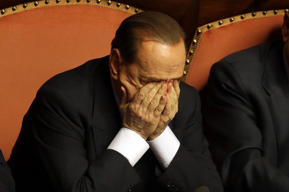 Silvio Berlusconi rubs his eyes after delivering a speech before the Italian Senate in Rome.
