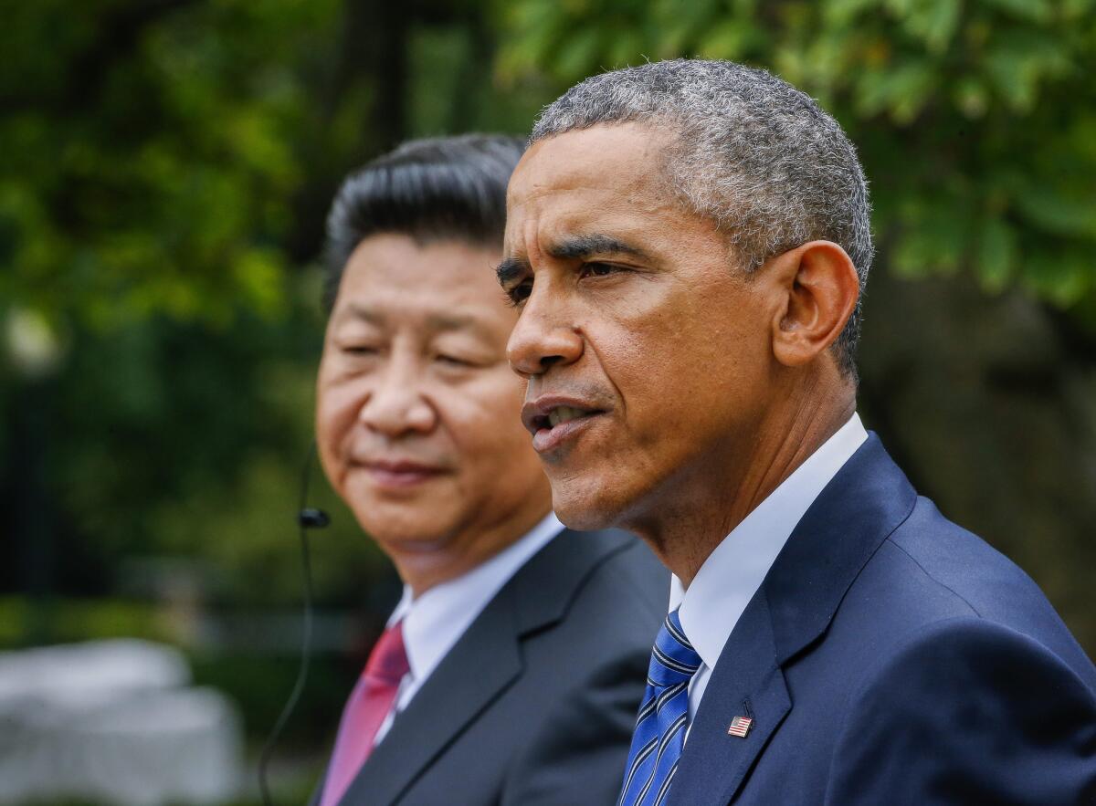 President Obama speaks at a news conference alongside Chinese President Xi Jinping in the Rose Garden of the White House on Friday.