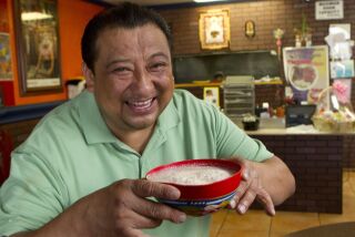 Owner of El Tejate Restaurant in Escondido, Simon Valencia, with a bowl of energy drink called tejate, also the namesake of the restaurant, which he called a "drink of the Gods."
