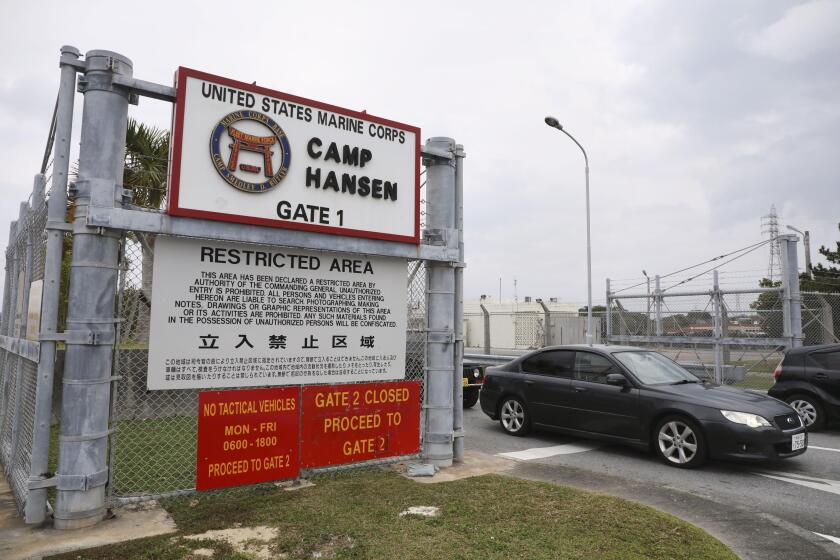 A vehicle leaves the U.S. Marine Corps' Camp Hansen, in Kin, Okinawa prefecture, southern Japan, on Jan. 5, 2022. The U.S. military on Thursday, Jan. 6, ordered personnel stationed in Japan to wear masks when going off base to curb the spread of COVID-19 infections. (Kyodo News via AP)