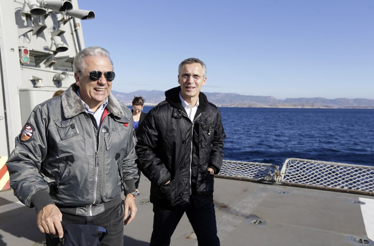 NATO Secretary-General Jens Stoltenberg, right, accompanied by Greece's Defense Minister Dimitris Avramopoulos aboard a Greek ship near Athens on Oct. 30. Stoltenberg was in Athens for talks that included renewed tension between Greece and Turkey over oil-and-gas exploration off the coast of divided Cyprus.