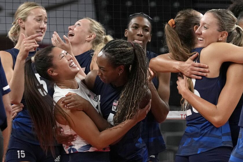 United States players celebrate winning the women's volleyball quarterfinal.