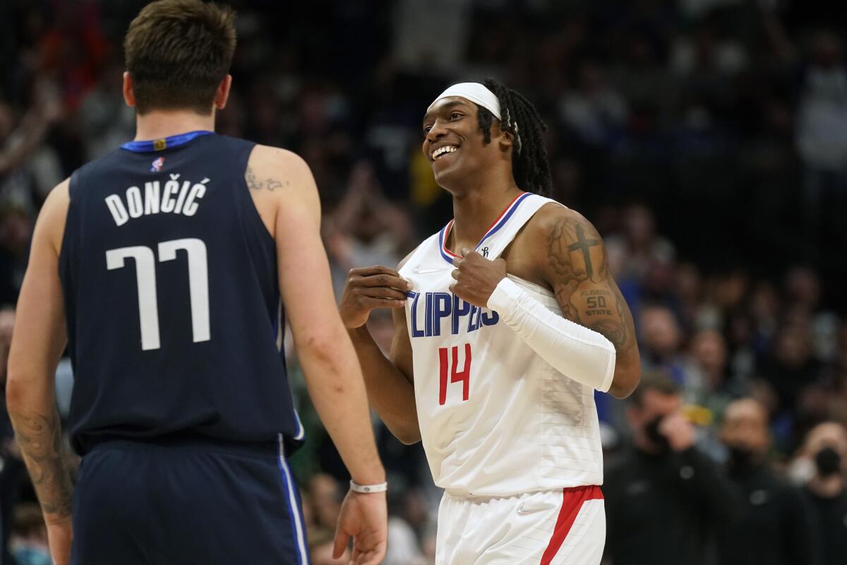 Clippers guard Terance Mann reacts to call after fouling Mavericks guard Luka Doncic.