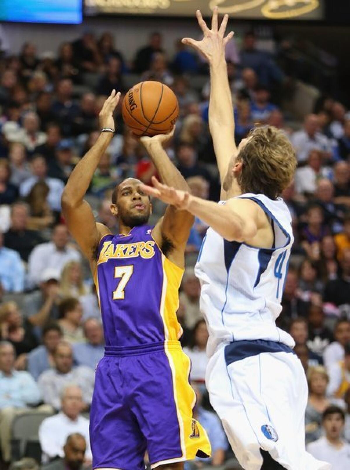 Lakers guard Xavier Henry shoots over Dallas Mavericks center Dirk Nowitzki during the Lakers' 123-104 loss Tuesday.