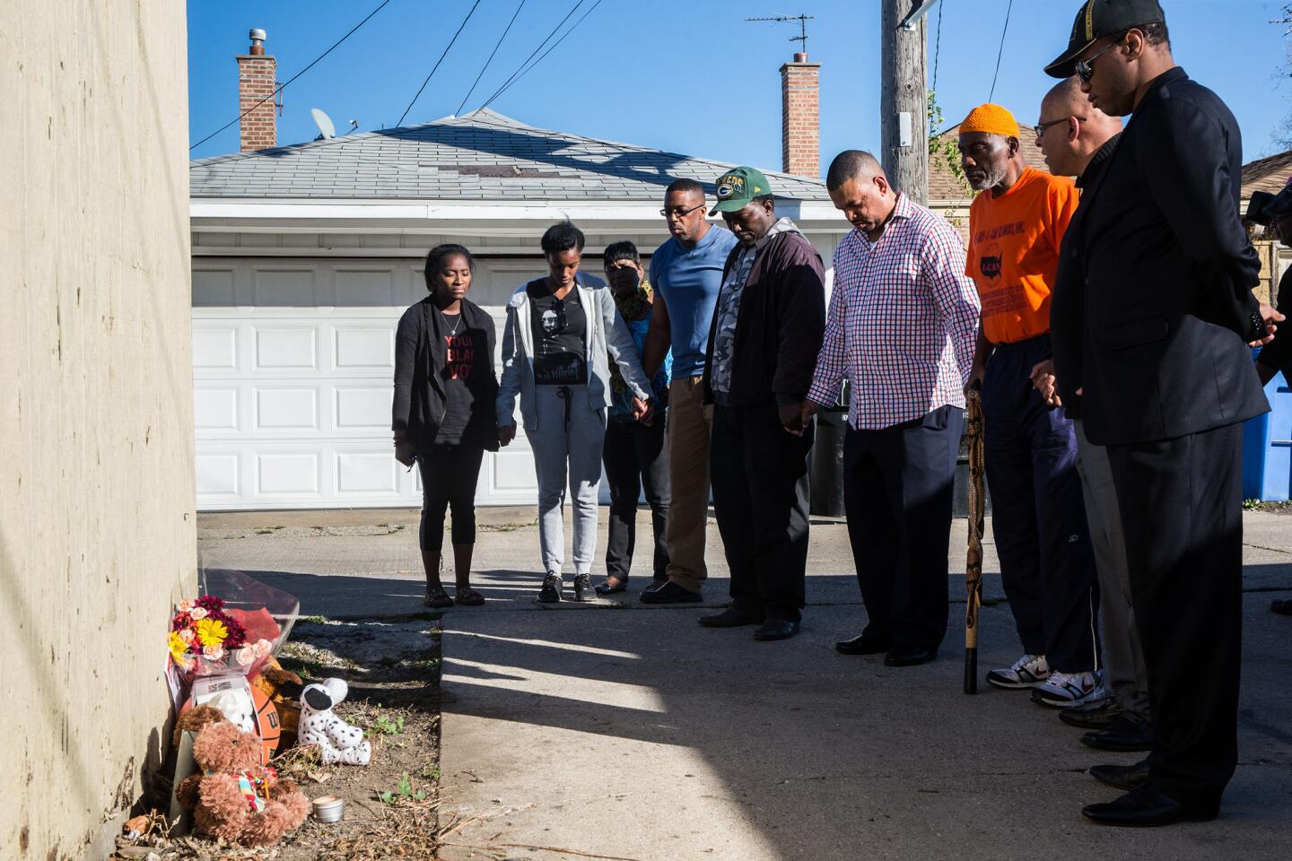 Community activists and parents pray at the memorial for 9-year-old Tyshawn Lee on Nov. 3, 2015. Lee was fatally shot a day earlier in Chicago's Gresham neighborhood in the 8000 block of South Damen Avenue.