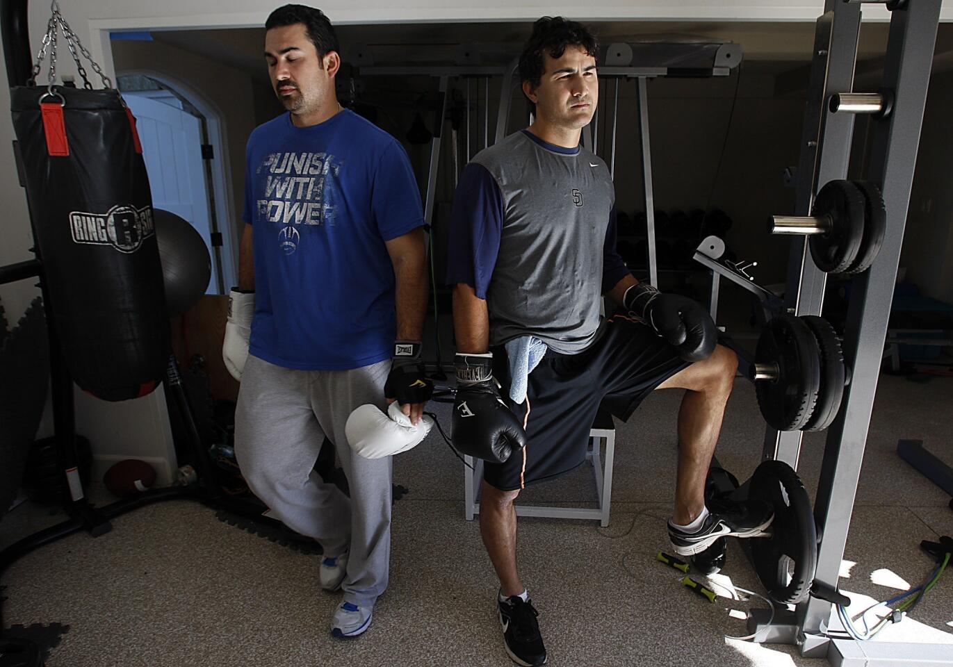 Dodgers first baseman Adrian Gonzalez, left, works out with brother Edgar in La Jolla, his offseason home.