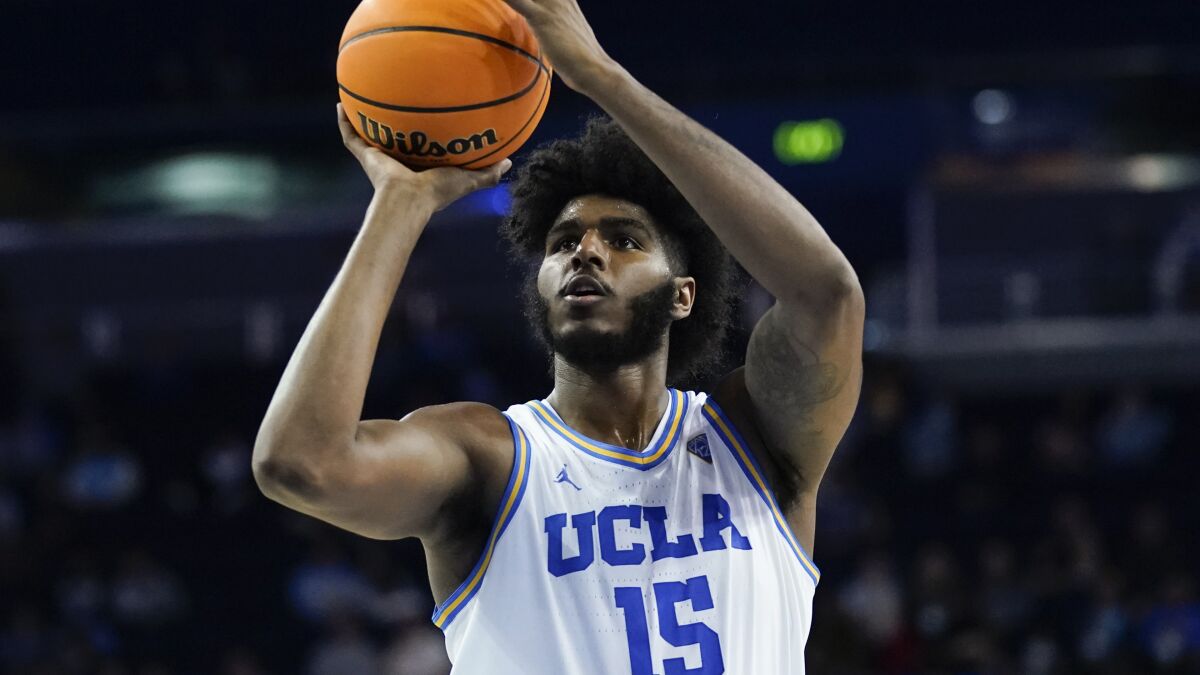 UCLA center Myles Johnson shoots during an NCAA college basketball game