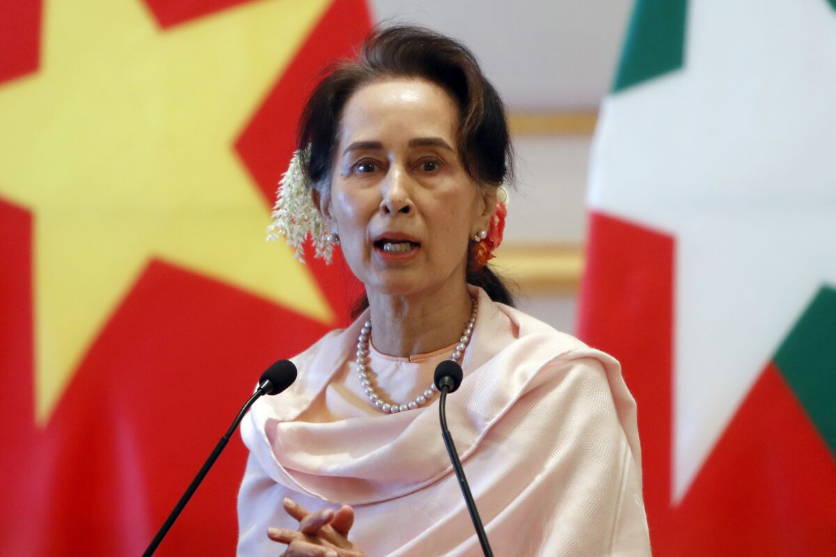 FILE - In this Dec. 17, 2019, file photo, Myanmar's former leader Aung San Suu Kyi speaks during a joint press conference with Vietnam's Prime Minister Nguyen Xuan Phuc after their meeting at the Presidential Palace in Naypyitaw, Myanmar. A court in Myanmar has agreed to change the venue for the trial of an Australian economist and advisor to Myanmar’s ousted leader Aung San Suu Kyi accused of violating the Southeast Asian nation’s official secrets law. (AP Photo/Aung Shine Oo, File)