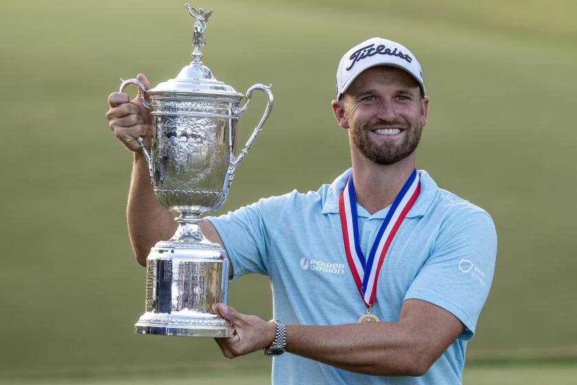 Wyndham Clark holds the U.S. Open championship trophy after winning at the Los Angeles Country Club on June 18.
