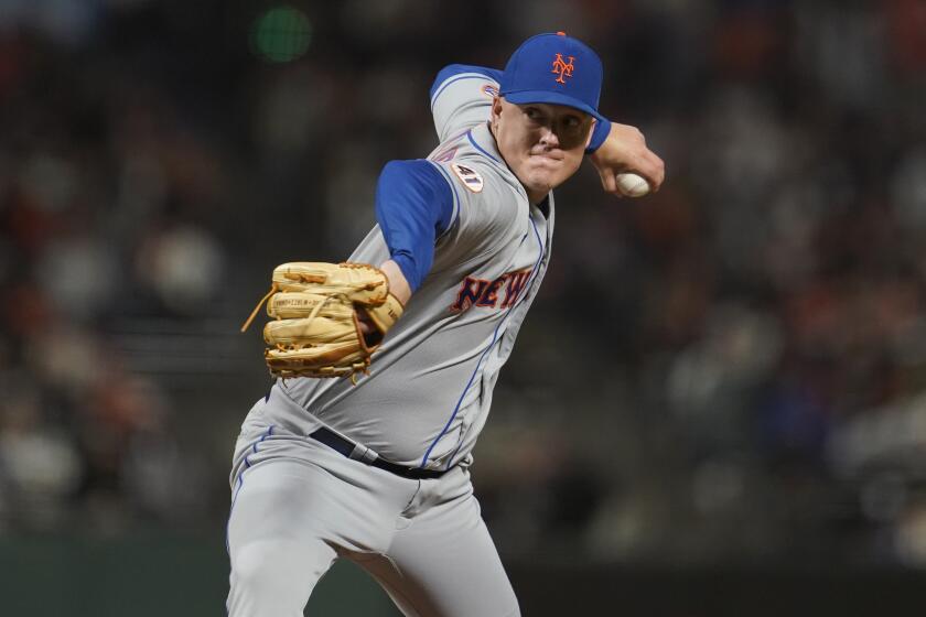 FILE - New York Mets pitcher Aaron Loup throws to a San Francisco Giants batter.