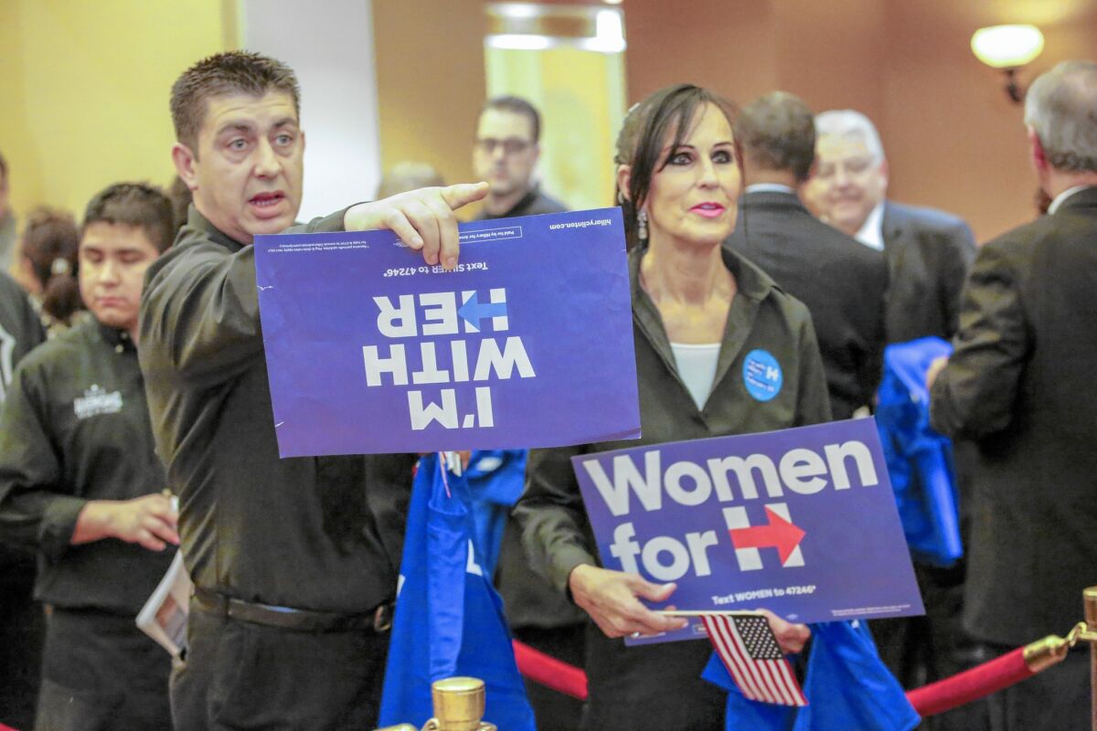 Agron Lejnullahu, left, and Gray Santoro line up to caucus for Hillary Clinton in Las Vegas.