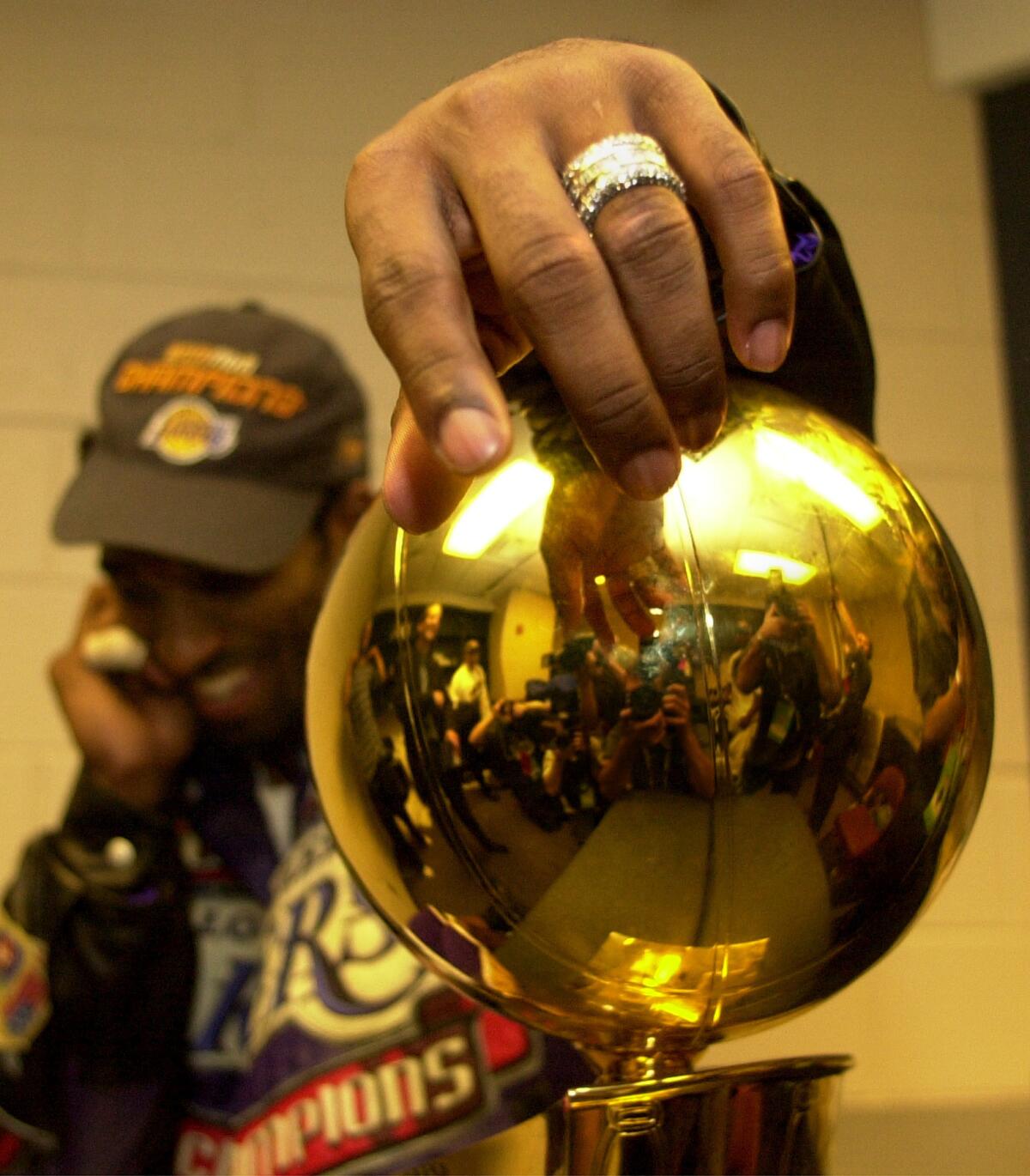 Kobe attempts a reverse layup along the baseline. (Robert Gauthier / Los Angeles Times). Kobe poses with the Championship trophy. (Wally Skalij / Los Angeles Times)