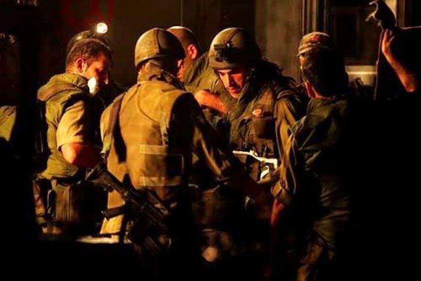 Israeli army medics attend to an injured soldier at a temporary field hospital set up on the Lebanese border. The Israeli security cabinet authorized the expansion of ground operations inside Lebanon with plans to push Hezbollah forces back to the Litani river.