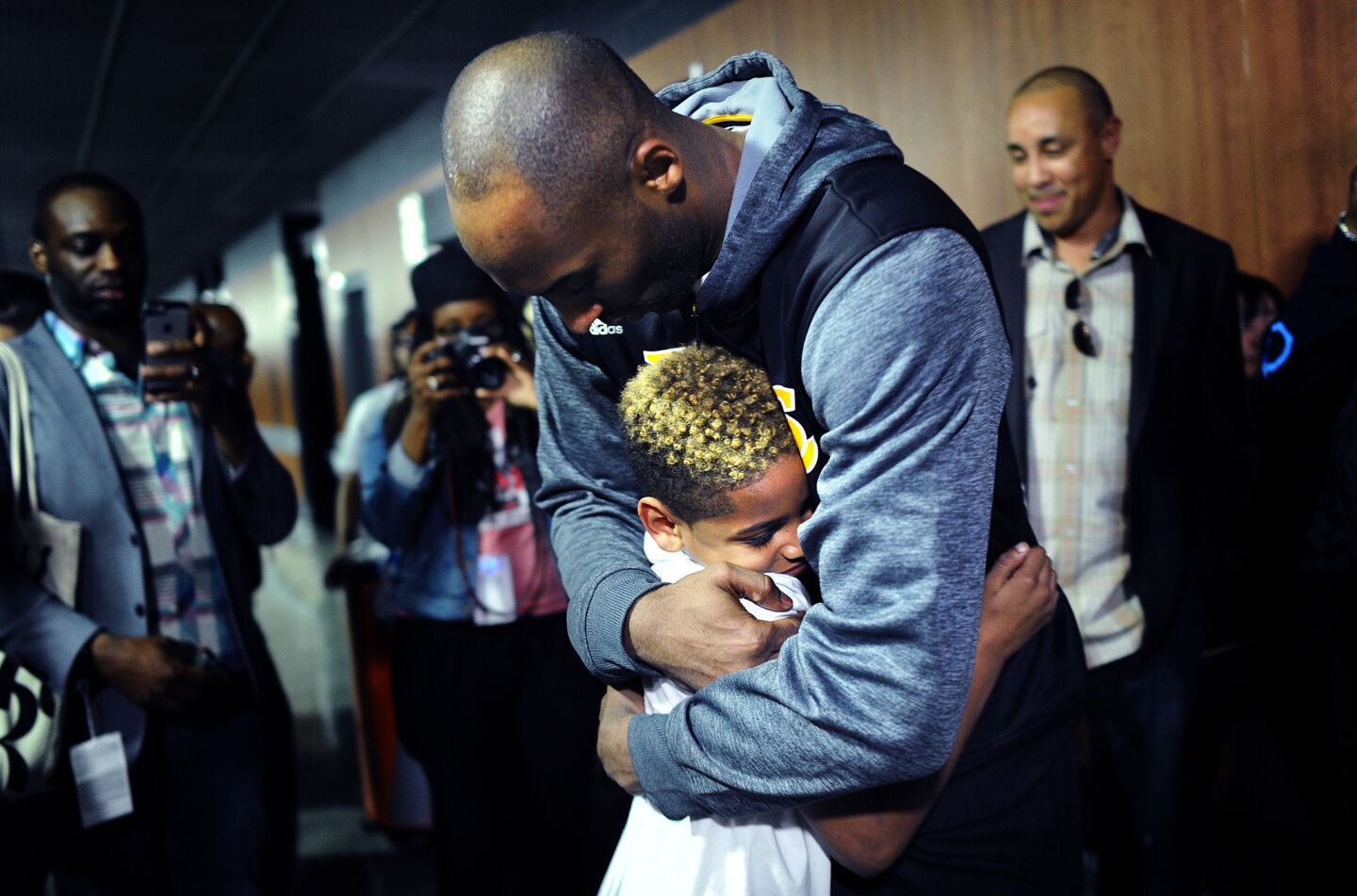 Kobe Bryant hugs Knicks Carmelo Anthony's son, Kiyan, after the game at the Staples Center.