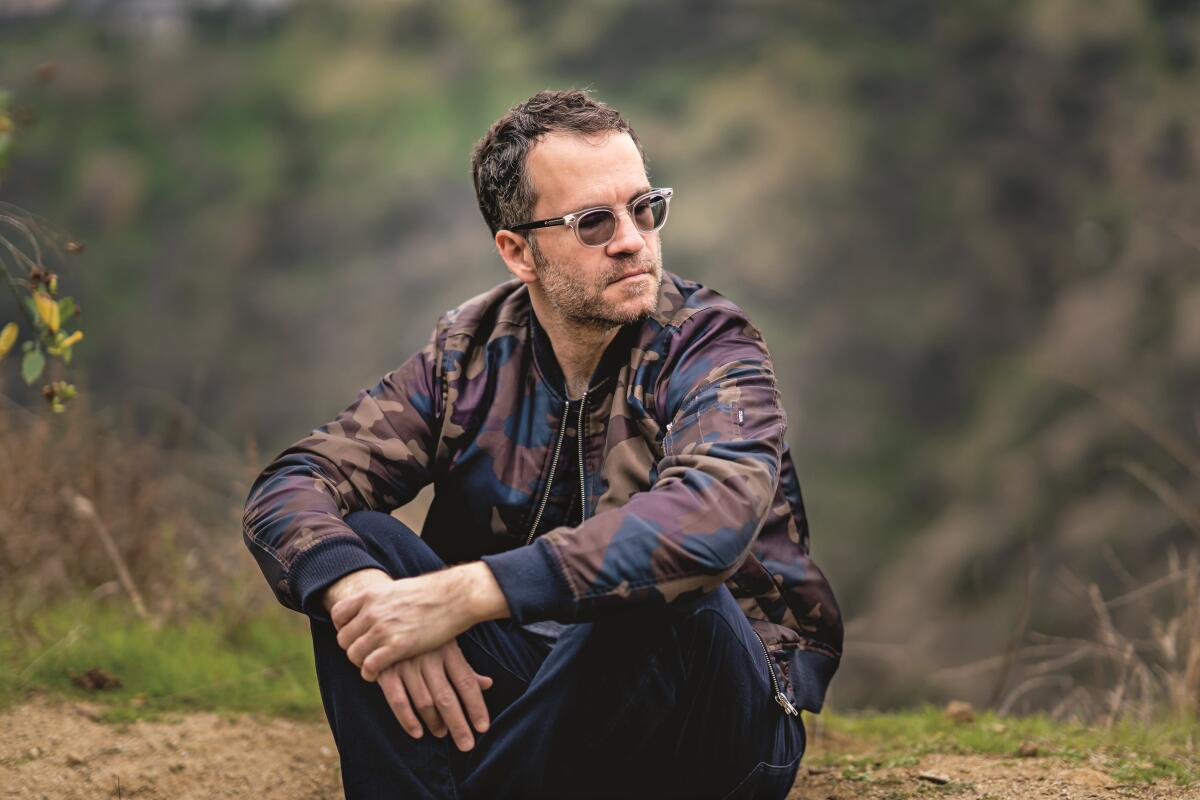 Author Tom Bissell sitting outside in usnglasses