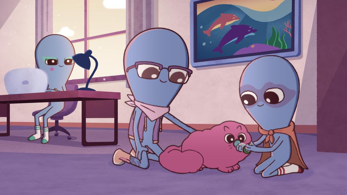 An alien sitting at a desk looks over at two aliens petting a pink cat.