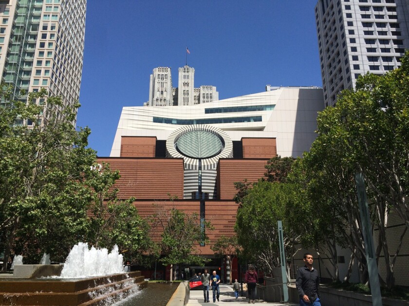The San Francisco Museum of Modern Art reopens to the public next month with a 10-story addition designed by Snohetta. The billowing expansion peaks out from behind the building's original Mario Botta-designed structure.