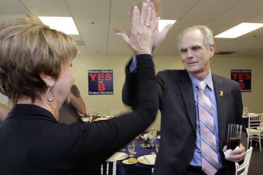 San Jose Mayor Chuck Reed, right, gives a high five as he arrives at a campaign party in San Jose in June 2012. His city approved a plan to roll back retirement benefits for public employees, but his statewide effort has hit a legal speed bump.