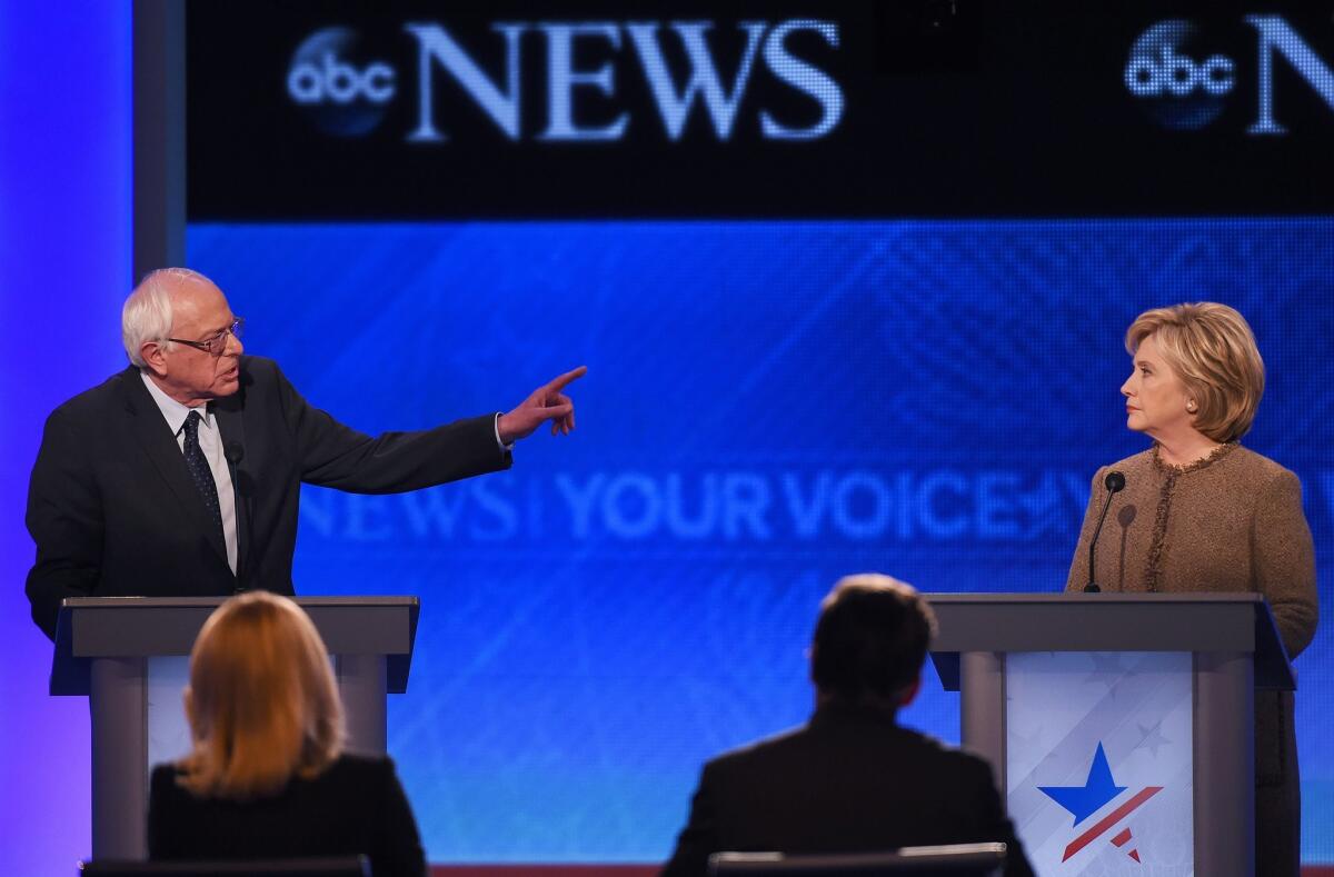US Democratic Presidential hopeful Bernie Sanders (L) speaks as Hillary Clinton looks on during the Democratic Presidential Debate hosted by ABC News at Saint Anselm College in Manchester, New Hampshire, on December 19, 2015. AFP PHOTO / JEWEL SAMADJEWEL SAMAD/AFP/Getty Images ** OUTS - ELSENT, FPG, CM - OUTS * NM, PH, VA if sourced by CT, LA or MoD **