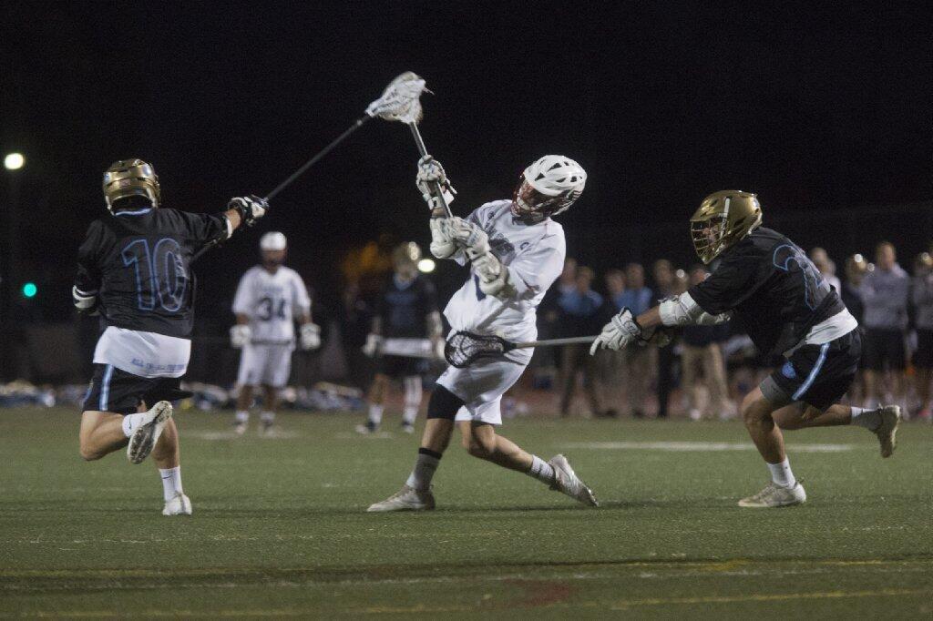 Newport Harbor's Hunter Rausch, center, shoots the ball against Corona del Mar during the Battle of the Bay.