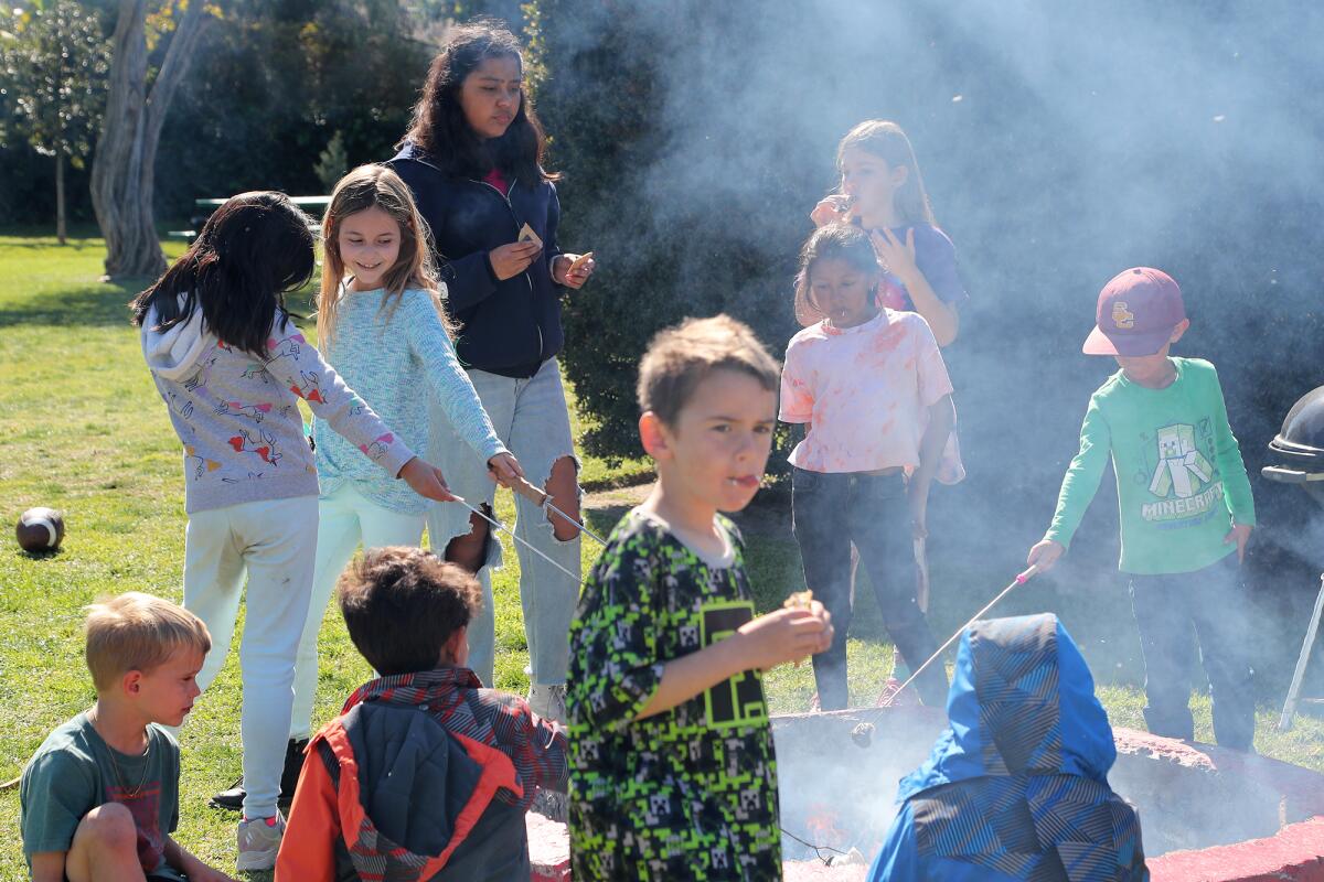 Students make s'mores Friday during "Presidents Week Camp" at the private, member owned Halecrest Park in Costa Mesa.
