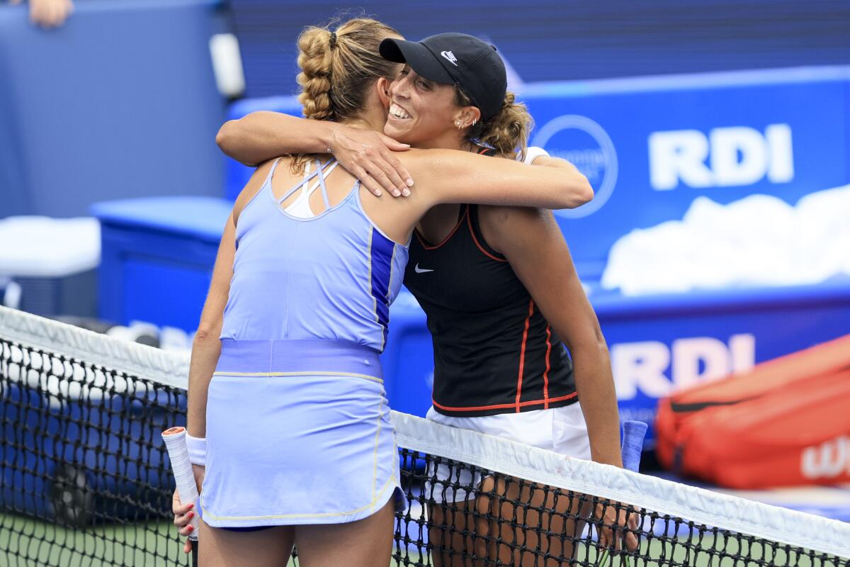 Petra Kvitova, left, of the Czech Republic, hugs Madison Keys, of the United States, after their match during the Western & Southern Open tennis tournament, Saturday, Aug. 20, 2022, in Mason, Ohio. (AP Photo/Aaron Doster)