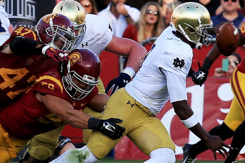 Notre Dame quarterback Malik Zaire, getting brought down by USC linebackers J.R. Tavai and Scott Felix (47) will make his first career start in the Music City Bowl on Tuesday when the Irish try to snap a five-game losing streak.