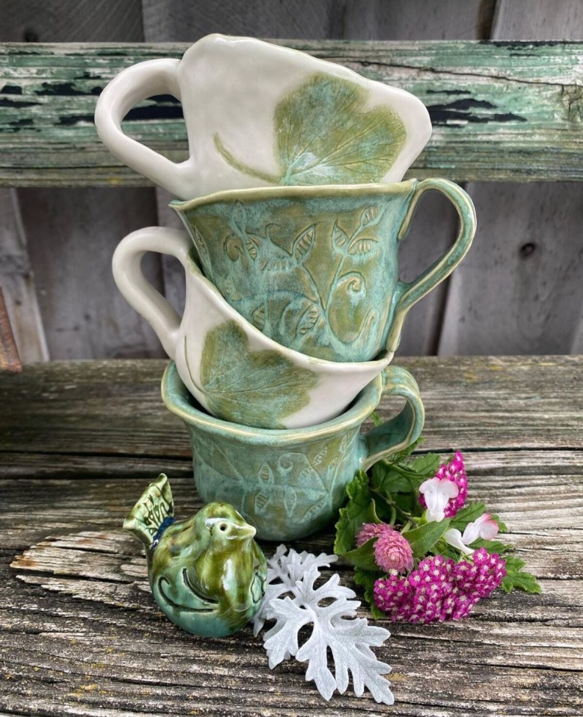 These mugs have flowers and herbs hand-pressed into them from the garden of vendor Sandra Lee of Petals and Pottery.