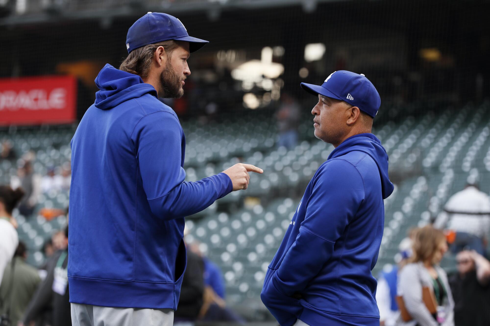 Dodgers' Clayton Kershaw talks with manager Dave Roberts before the game.