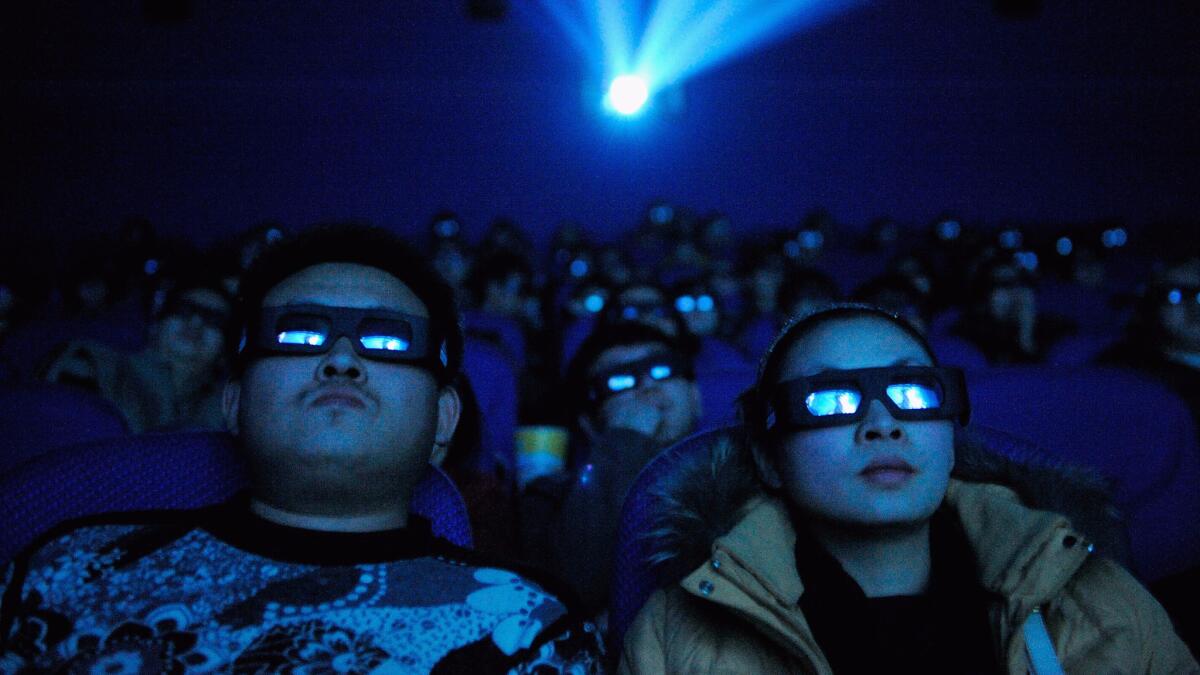 An audience watches the 3D film 'Avatar' through 3D glasses at a cinema in the Taiyuan, Shanxi province of China.