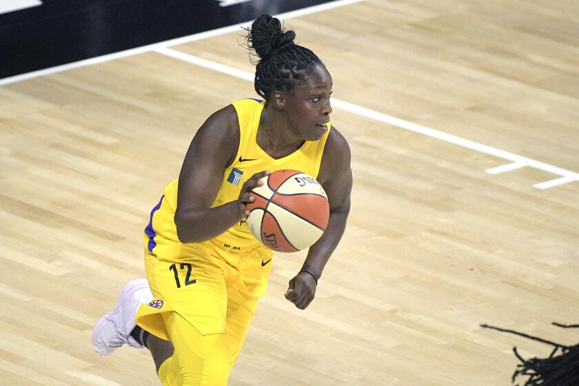 Los Angeles Sparks guard Chelsea Gray (12) brings the ball up the court.