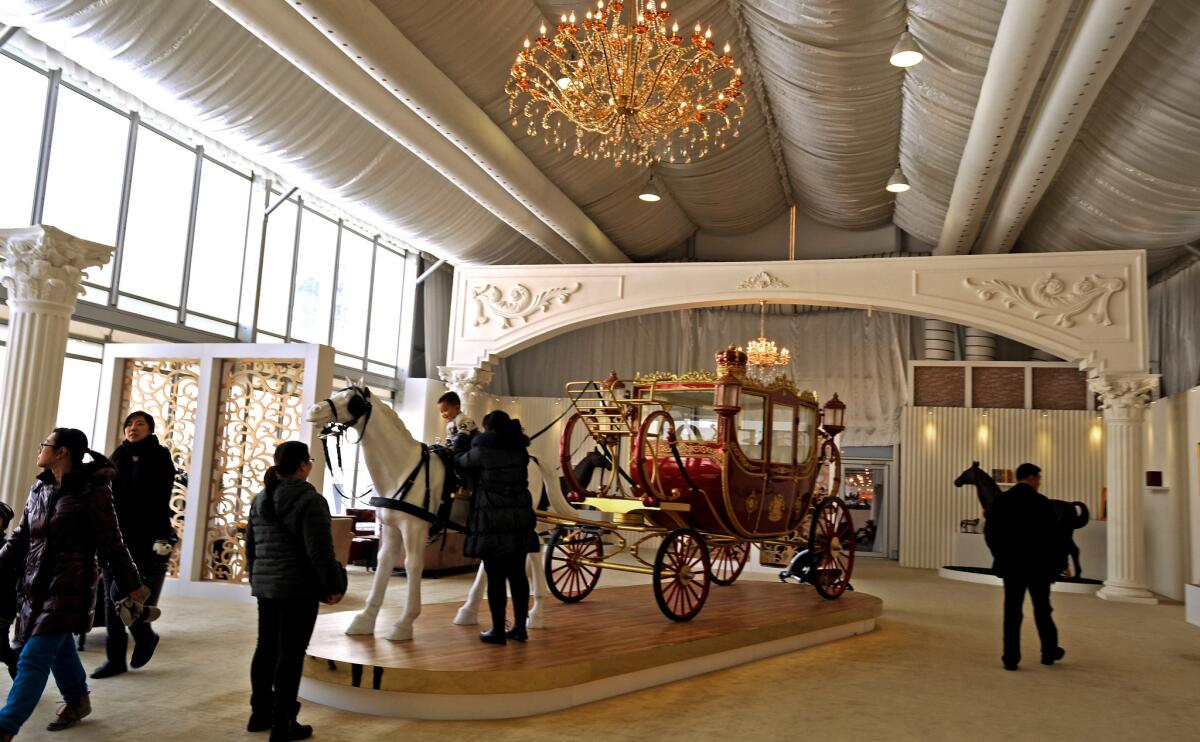 A life-size horse mannequin is harnessed to a carriage in the clubhouse at Tianjin Goldin Metropolitan Polo Club. The room also contains models of the entire property development, which features the polo club, apartments, a hotel, standalone homes (known as villas) and a business district with 11 skyscrapers. Apartments start at $1 million and the top-end mansion is priced at $90 million.