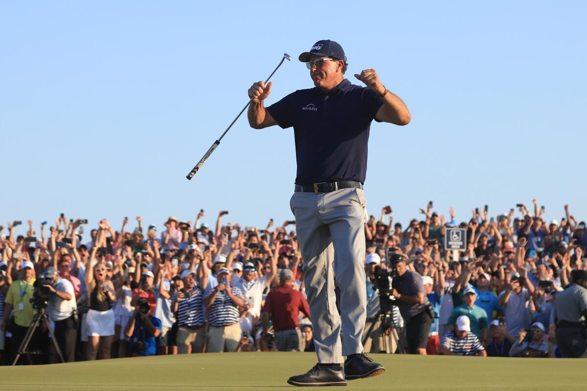 Phil Mickelson of the United States celebrates on the 18th green after winning Sunday's PGA Championship.