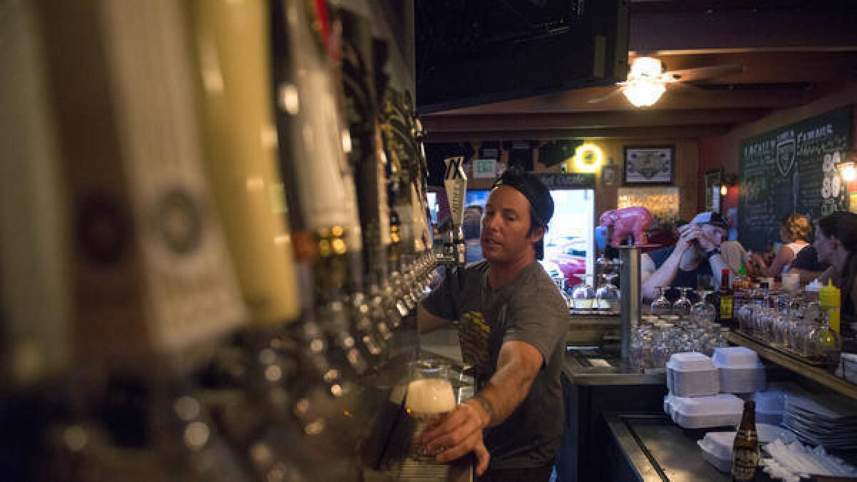 Jared Hodge pours a beer at Encinitas Ale House in 2015.